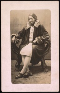 Gladys Dowdell, wearing fur collard coat, full-length studio portrait, seated, facing front LCCN2015650013