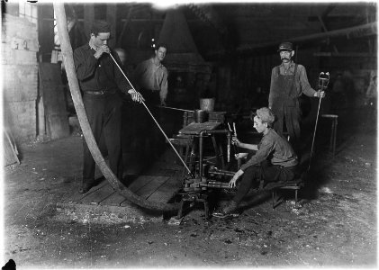 Glass blower and mold boy. Boy has 4 1-2 hours of this at a stretch, then an hour's rest and 4 1-2 more, cramped... - NARA - 523090