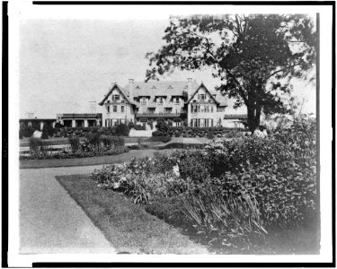 Facade of home of Edmund Cogswell Converse, with flowers in foreground, Greenwich, Connecticut LCCN94502477