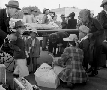 Family detail, Woodland, California. Families of Japanese ancestry with their baggage at railroad station awaiting . . . - NARA - 537806 (cropped) photo