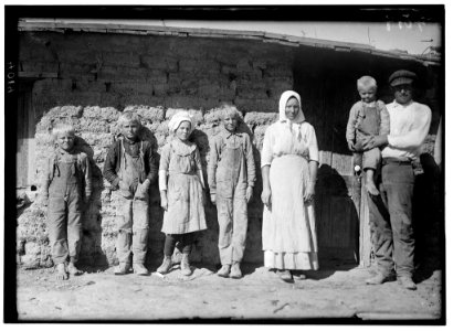 Family of Fred Karb and their mud shack - beet workers near Sterling, Colo. They all work from 5-30 A.M. to 7-00 P.M. with about an hour for lunch. The 6 and 8 yr. olds pull and pile, -10 LOC nclc.05583
