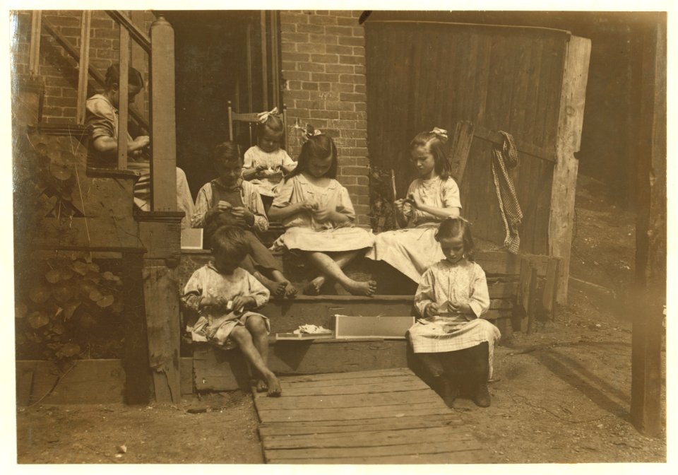 Family of Mrs. Donovan, 293 1-2 Highland Street, Roxbury, Mass., tying tags for Dennison Co. This is the family that has worked on tags for 7 years and makes an average from that work $30 a LOC cph.3b41011