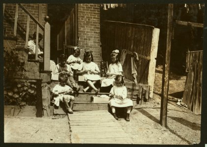 Family of Mrs. Donovan, 293 1-2 Highland Street, Roxbury, Mass., tying tags for Dennison Co. This is the family that has worked on tags for 7 years and makes an average from that work $30. LOC nclc.04249