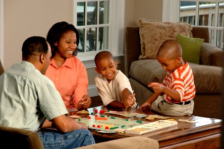 Family playing a board game photo