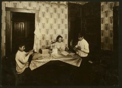Family of David H. Goodman, cor. Coburn and Mellen Streets, South Framingham, Mass. Mother and two children, 14 yrs. and 10 yrs. old, working on tags for Dennison factory. One boy, 12 yrs. LOC nclc.04291