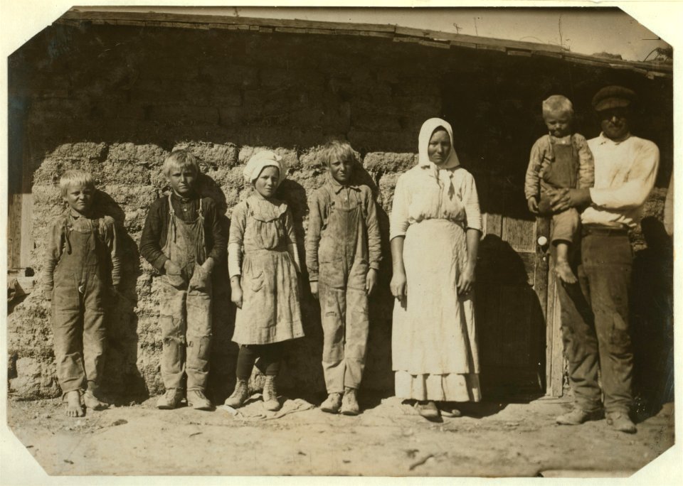 Family of Fred Karb and their mud shack - beet workers near Sterling, Colo. They all work from 5-30 A.M. to 7-00 P.M. with about an hour for lunch. The 6 and 8 yr. olds pull and pile, -10 LOC nclc.05583