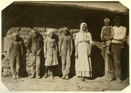 Family of Fred Karb and their mud shack - beet workers near Sterling, Colo. They all work from 5-30 A.M. to 7-00 P.M. with about an hour for lunch. The 6 and 8 yr. olds pull and pile, -10 LOC nclc.05583