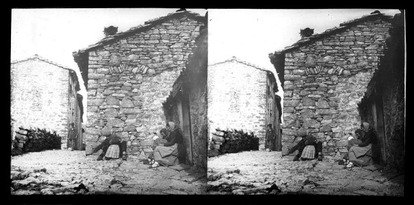 Família asseguda a la vorera d'un carrer de Castellar de n'Hug