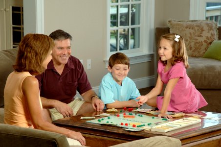 Family playing a board photo