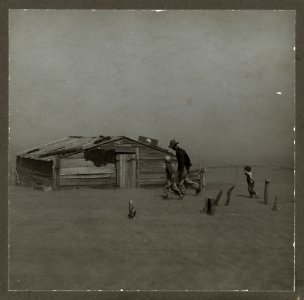 Farmer walking in dust storm Cimarron County Oklahoma
