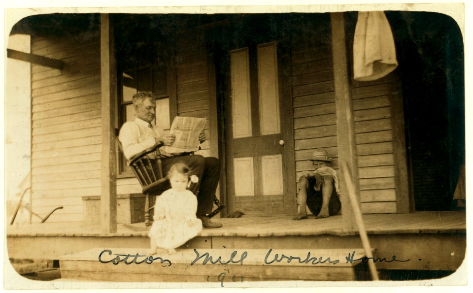 Father taking it easy at home while his two girls work in the cotton mill. LOC nclc.00882