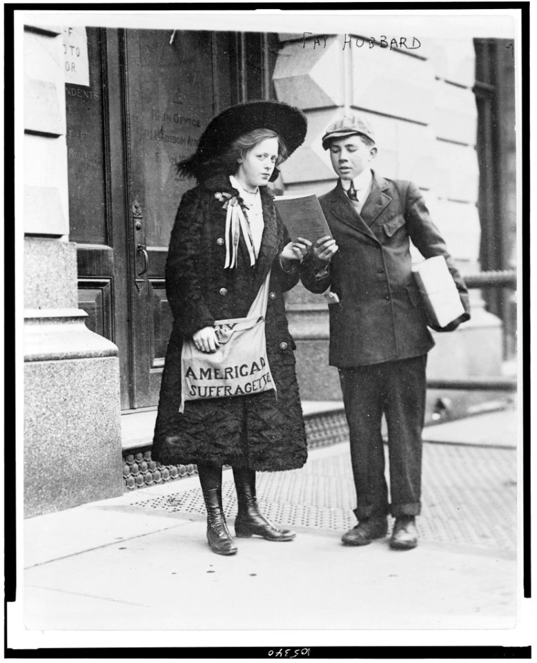Fay Hubbard, 19-year old suffragette, full-length portrait, standing, selling suffragette papers LCCN92510578
