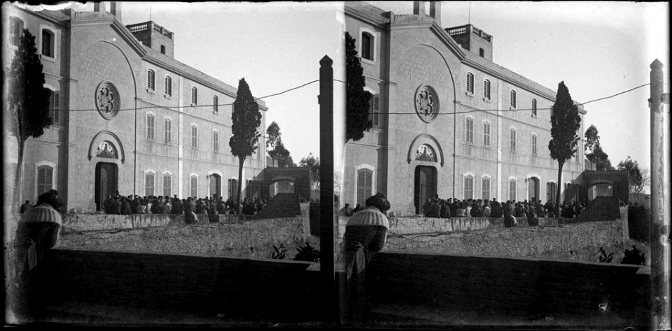 Façana de l'hospital psiquiàtric de Betlem a Sant Gervasi i gent al davant , en primer terme una dona