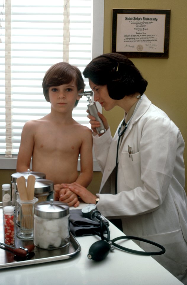 Female doctor examines a child photo