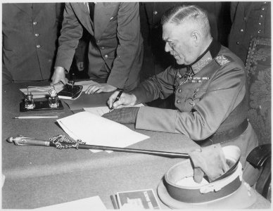Field Marshall Wilhelm Keitel, signing the ratified surrender terms for the German Army at Russian Headquarters in... - NARA - 531290