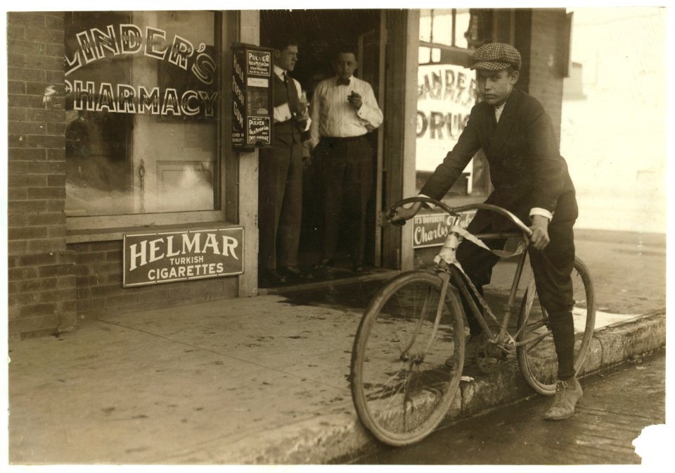 Fifteen year old delivery boy for Linders Drug Store, which is located on the edge of the Reservation, Griffin Street. The boy has just returned from a trip to these Houses. He works from 8 LOC nclc.03899