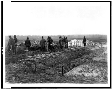 Filling in the graves at Fère-en-Tardenois cemetery - Signal Corps, U.S.A. LCCN91720336