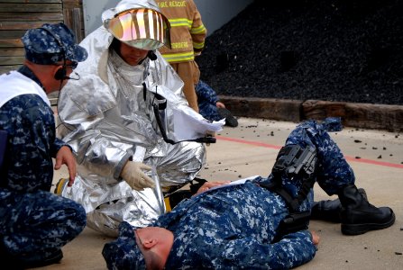 Fire fighters assist simulated wounded during a drill. (8509274965) photo