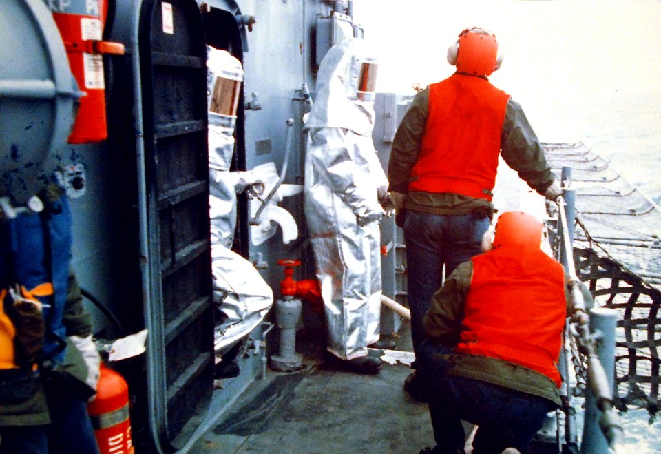 Fire party on standby during flight operations aboard USS Pharris (DE-1094) 1975 428-GX-K 107939