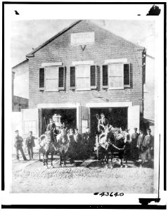 Fireman with firefighting equipment in front of the Vigilant Firehouse, 1066 Wisconsin Avenue Northwest, Washington, D.C. LCCN93510984