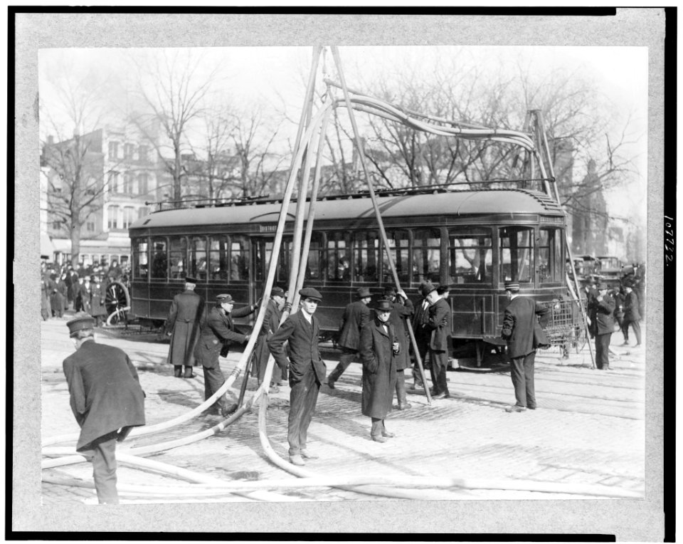 Firemen with hoses over streetcar LCCN93505089