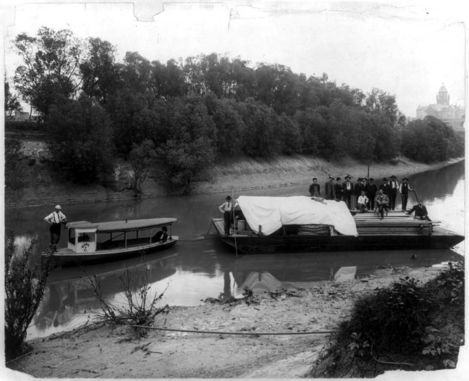 First barge loaded with supplies leaving Dallas port for the first dock and dam on the Trinity River, Texas. Barge drawn by Burk & Co. boat LCCN2005696154