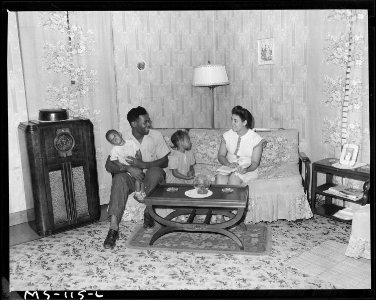 Gonzalla Sullivan, miner, with his wife and children in living room of their home in company housing project. Koppers... - NARA - 540281 photo