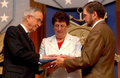 Gordon England presents the Medal of Honor flag to Ross McGinnis's parents