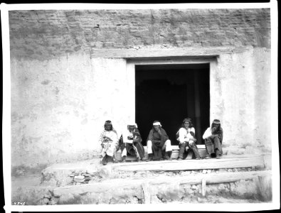 Governor Eusebius and his staff sitting on the steps of the old church, Acoma Pueblo, New Mexico, 1886 (CHS-4545)