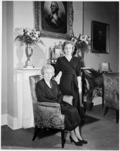 First Lady Bess Truman poses with her daughter, Margaret, for a portrait photograph in front of the fireplace at... - NARA - 200024