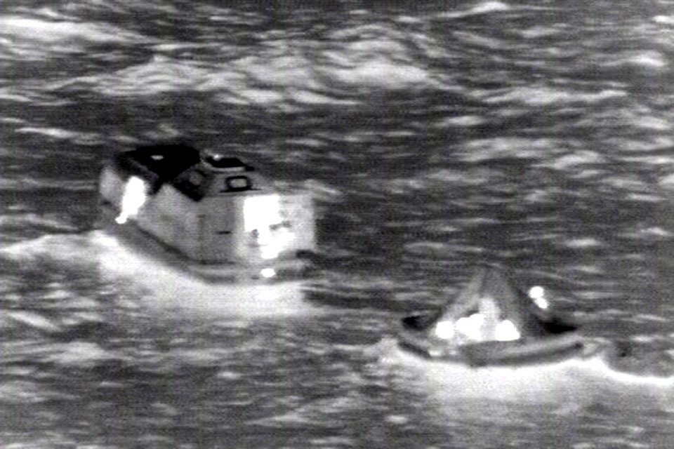 Fishermen from the Taiwanese fishing vessel Shin Maan Chun man a life raft after a fire aboard their boat forced the them to abandon ship. 120421-N-ZZ999-002