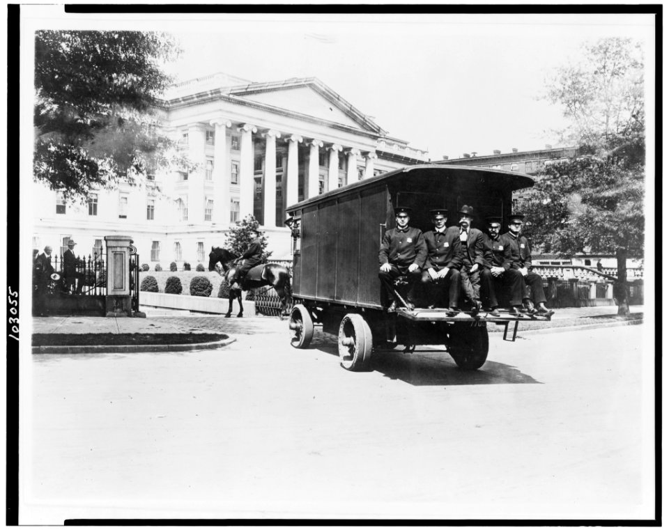 Five policemen sitting on back of van and policeman on horseback; outside south side of the Treasury Building, Washington, D.C. LCCN91725974