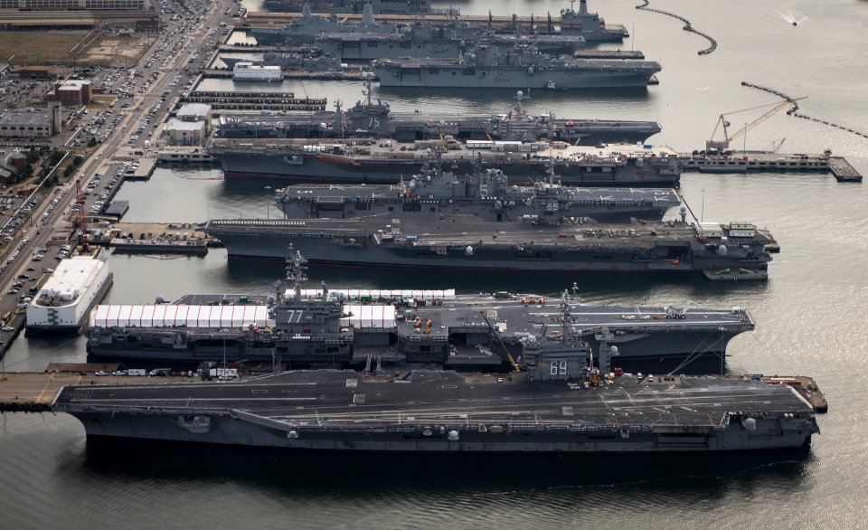 Five carriers and four amphibious ships moored at Norfolk. (8293467239)