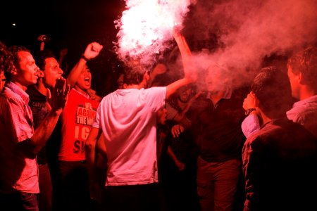 Flares illuminate the gathering of several hundred Third Square supporters