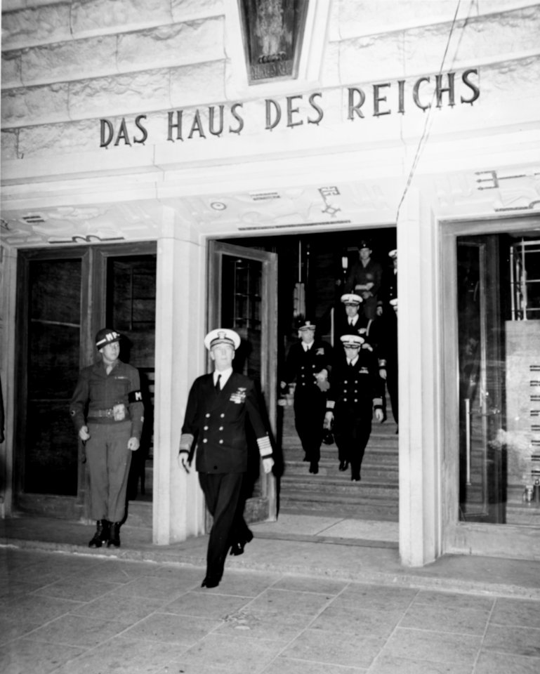 Fleet Admiral Ernest J. King leaves the headquarters of US Ports and Bases in Bremen, Germany, 23 July 1945