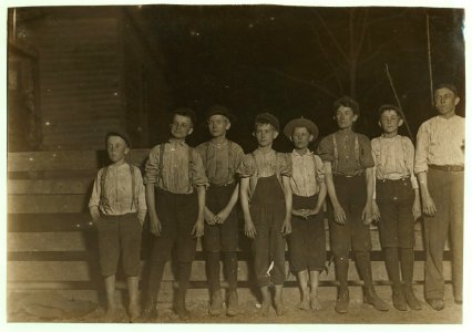 Flashlight at 6 P.M. Doffer boys in Strickland Mill, Valdosta, Ga. Boy in middle and one on right hand end been in mill work for 7 yrs. Others from 1 to several years. Smallest boy does not LOC nclc.01629