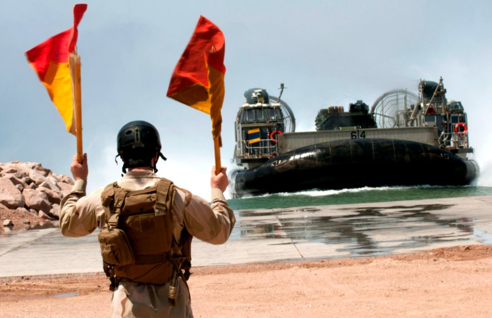 Flickr - Official U.S. Navy Imagery - A Construction Mechanic guides a landing craft air cushion ashore.