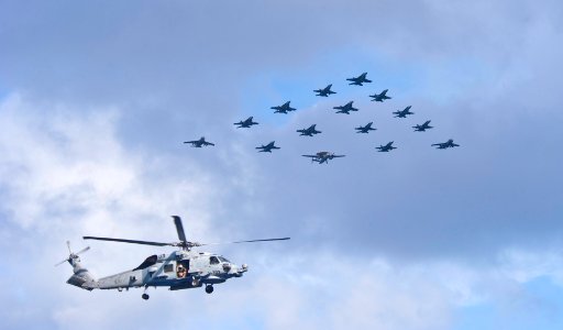Flickr - Official U.S. Navy Imagery - A helicopter flies over tiger cruise families during an air power demonstration.
