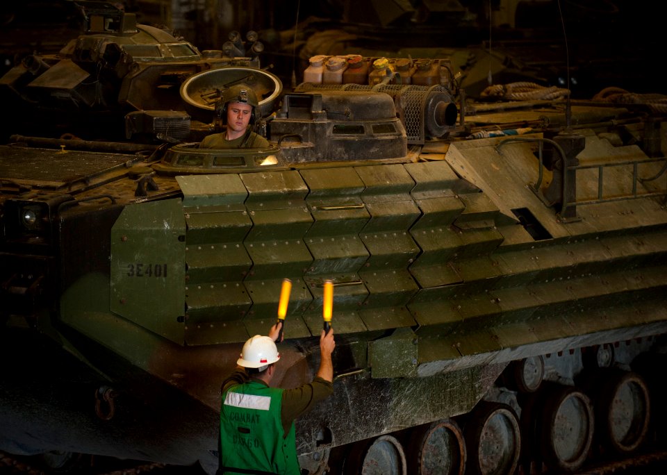 Flickr - Official U.S. Navy Imagery - A Marine guides an amphibious assault vehicle in the well deck of USS New Orleans.