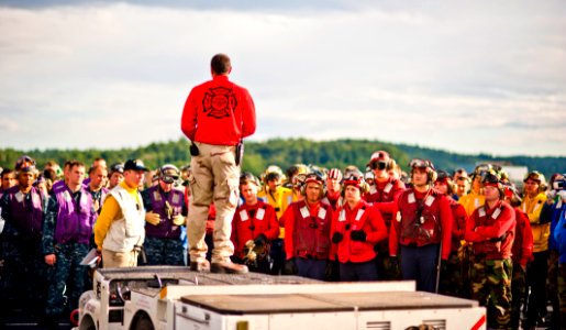 Flickr - Official U.S. Navy Imagery - A Navy Officer briefs Sailors prior to flight deck fire fighting drills.