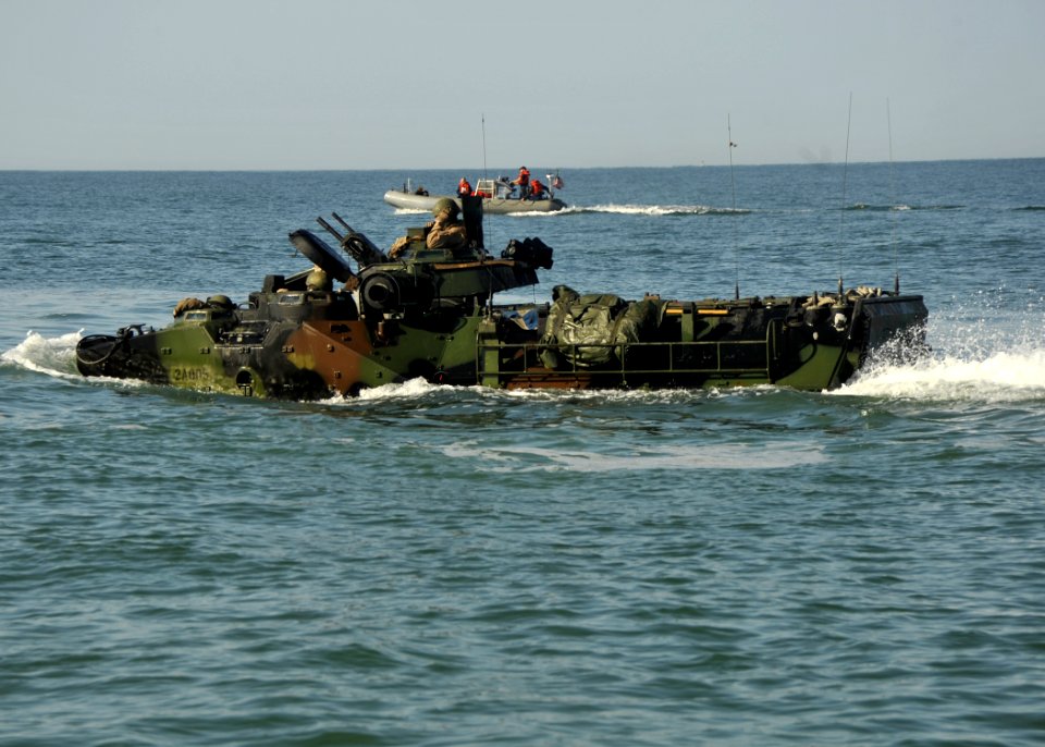 Flickr - Official U.S. Navy Imagery - A Rigid Hull Inflatable Boat escorts an Amphibious Assault Vehicle.