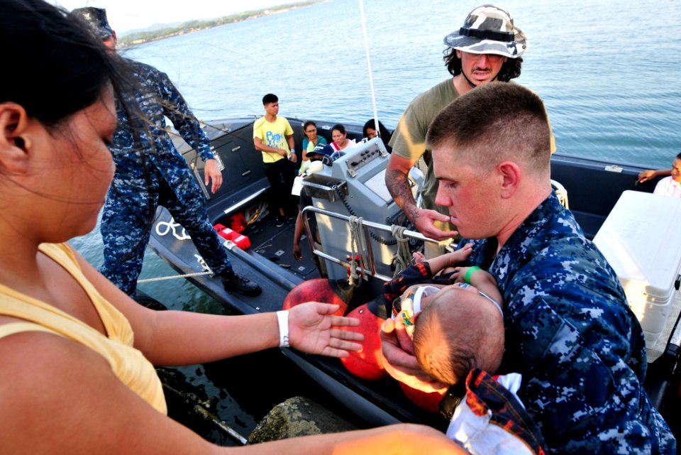 Flickr - Official U.S. Navy Imagery - A Sailor assists in transporting an infant patient into a Band-Aid boat.