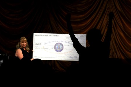 Flickr - Official U.S. Navy Imagery - A guest at the Navy-Marine Corps Relief Society Ball jumps in excitement during the announcement that recent fund raising efforts helped the NMCRS raise more than half of a million dollars.