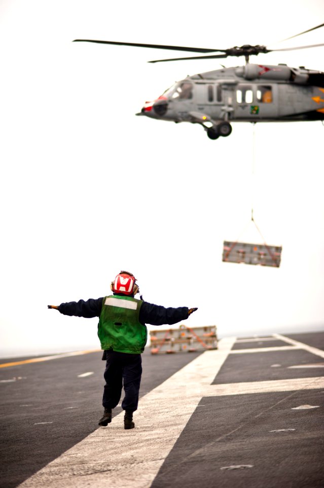 Flickr - Official U.S. Navy Imagery - A Sailor directs a helicopter. (3)