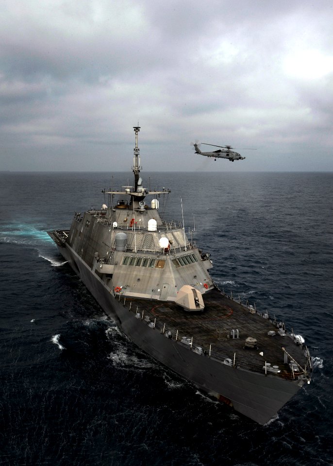 Flickr - Official U.S. Navy Imagery - A helicopter flies near USS Freedom.