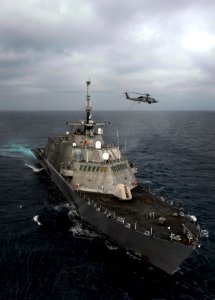 Flickr - Official U.S. Navy Imagery - A helicopter flies near USS Freedom.