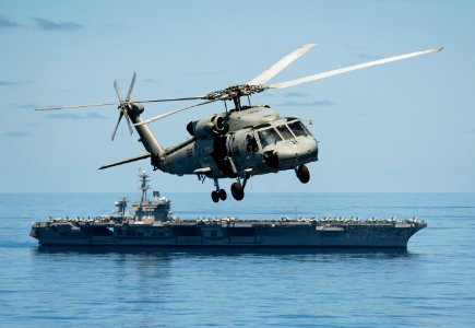 Flickr - Official U.S. Navy Imagery - A helicopter flies past USS Carl Vinson.