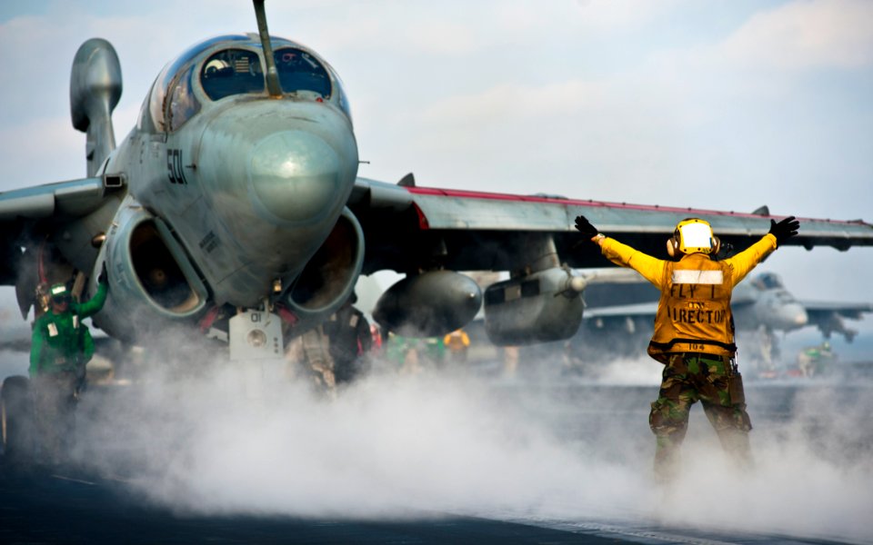 Flickr - Official U.S. Navy Imagery - A Sailor directs an EA-6B Prowler.