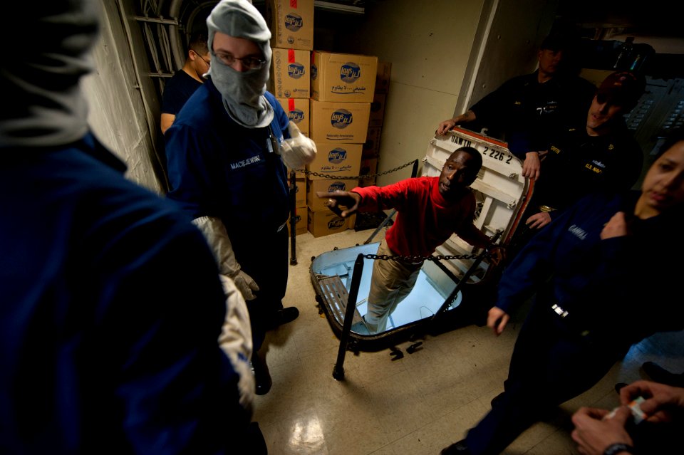 Flickr - Official U.S. Navy Imagery - A Sailor directs members of the at-sea fire party as they respond to simulated flooding drill.