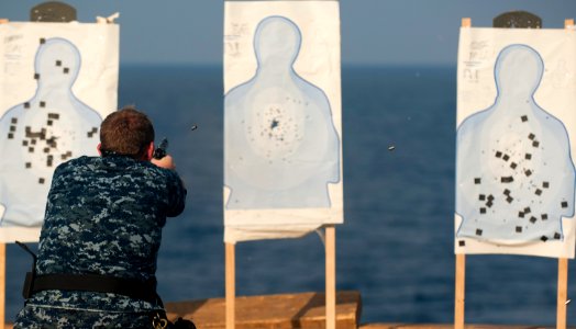 Flickr - Official U.S. Navy Imagery - A Sailor fires a 9 mm service pistol at a target during a live-fire small arms qualification.